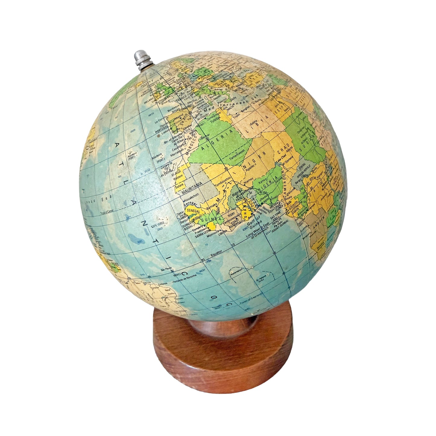 Vintage-style world globe on a wooden stand with a white background