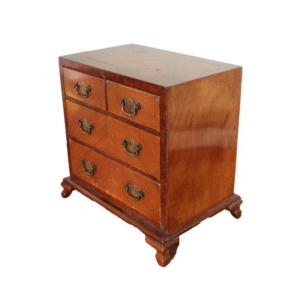 Wooden chest of drawers with four drawers on a white background