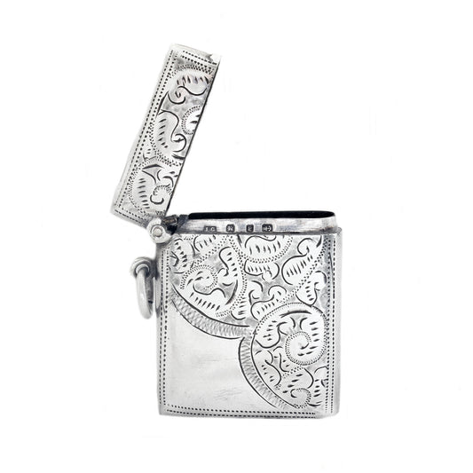 Silver vesta with intricate paisley patterns on a white background
