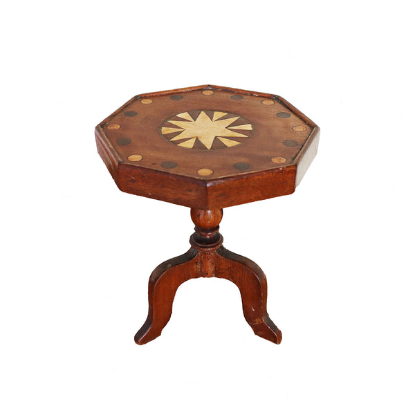 Hexagonal wooden table with starburst design on a white background