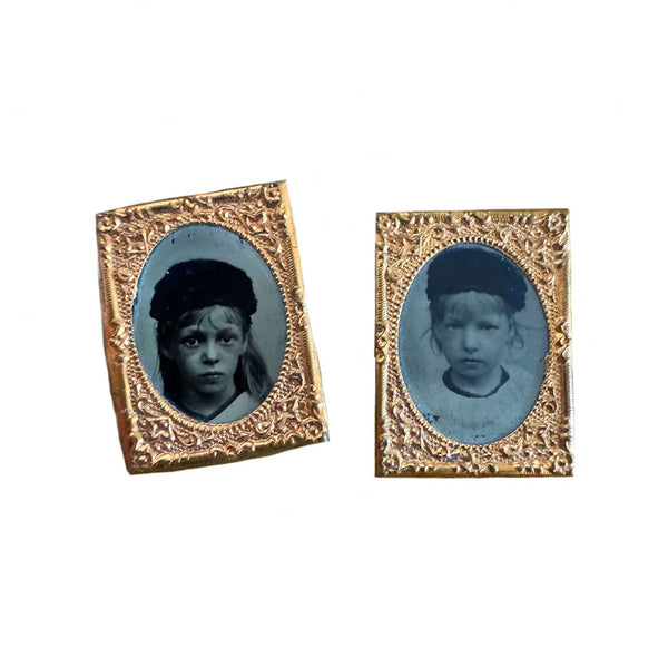 Two vintage portraits in ornate gold frames on a white background