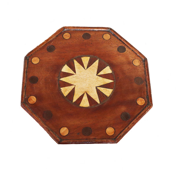 Wooden octagonal board with star-shaped center on a white background