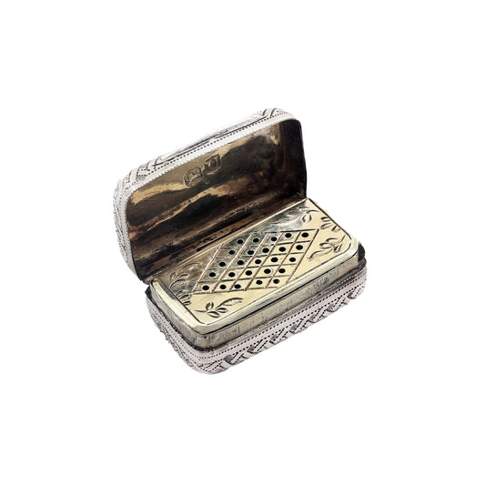 Decorative silver and gold box with intricate patterns on a white background