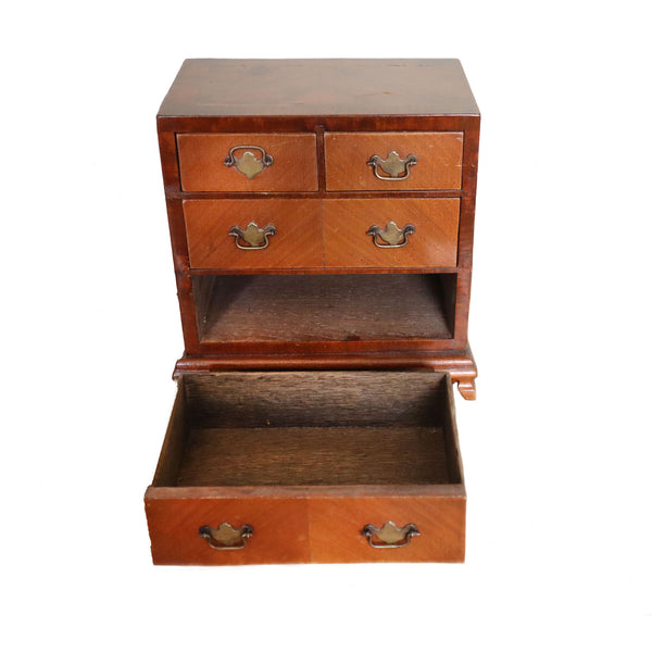Wooden chest with multiple drawers on a white background