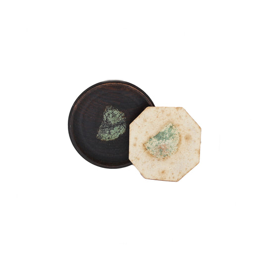circular black box and hexagonal seal underneath