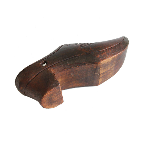 an antique miniature brown clog lying on its side showing the short heel