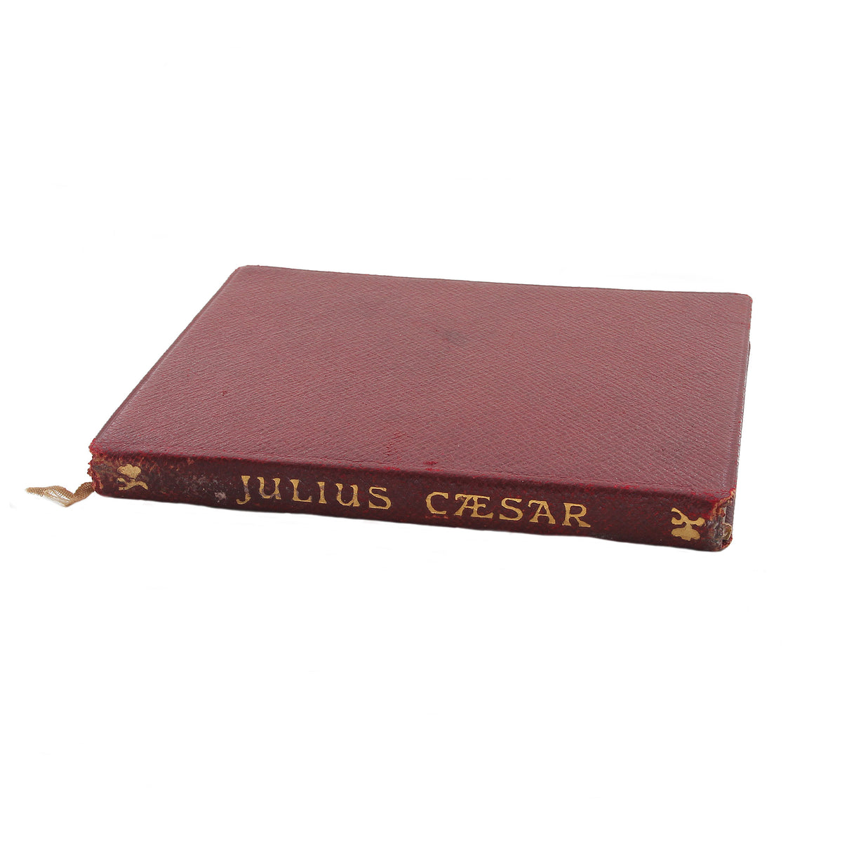 A secondhand little Julius Caesar book with red cover dated 1903