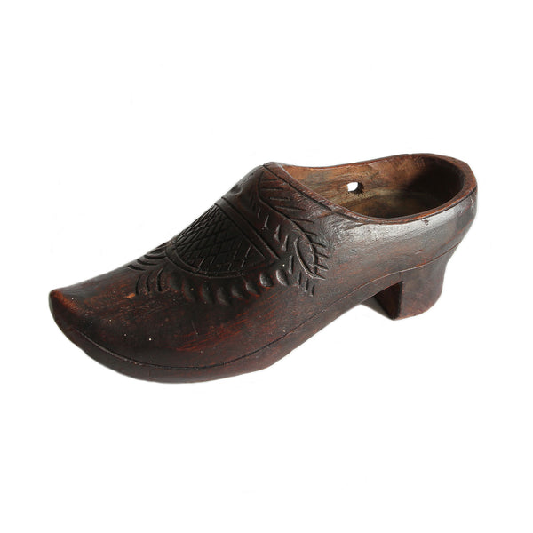 Antique wooden clog shoe with a floral design and a small heel.