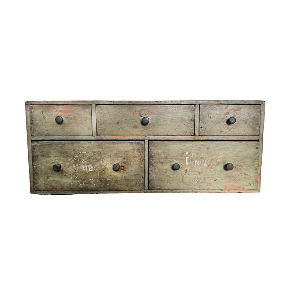 wooden dresser with five drawers on a white background