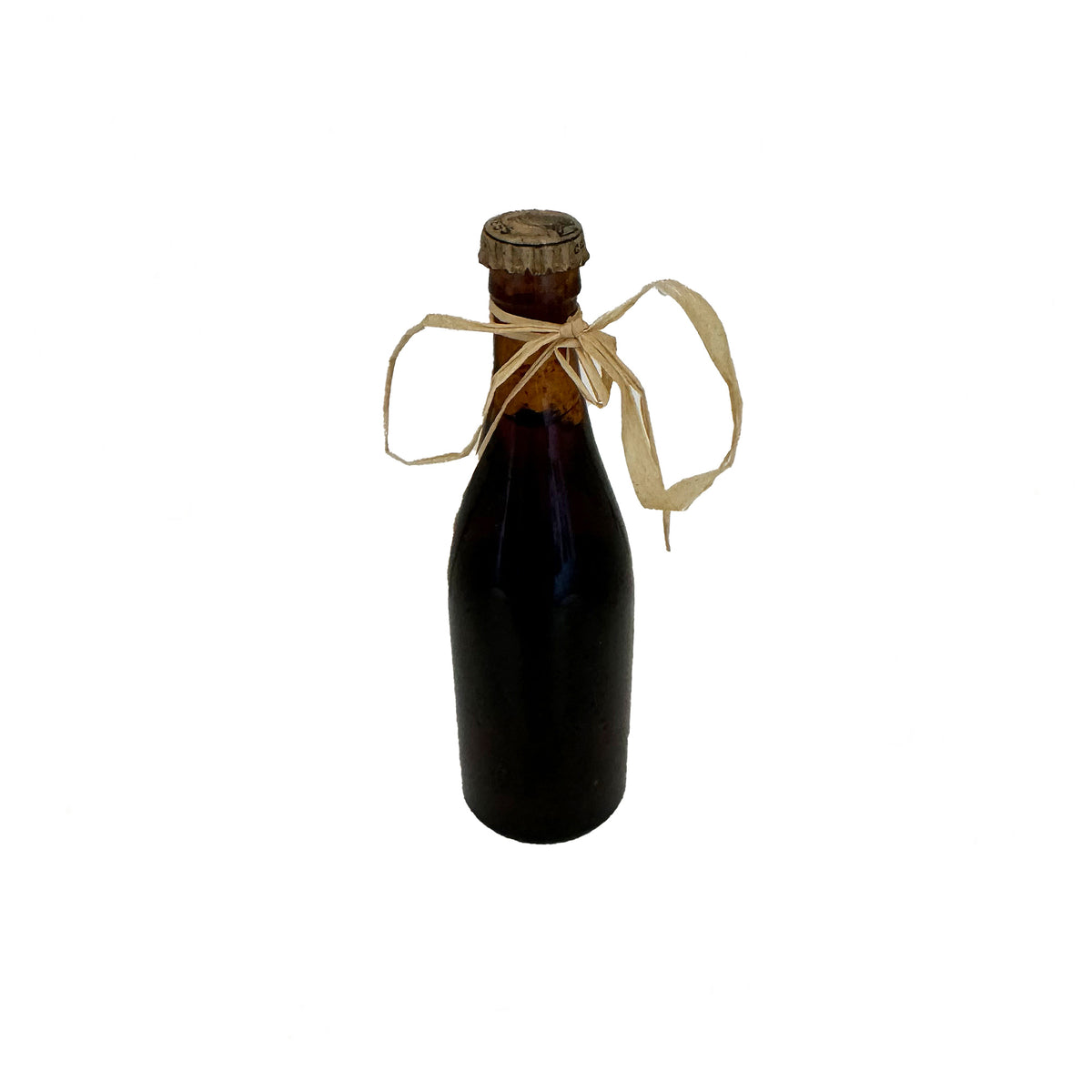 a vintage miniature bottle of guinness with contents and label