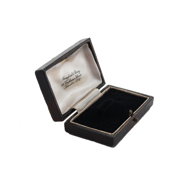 Open black jewelry box with a white interior on a white background