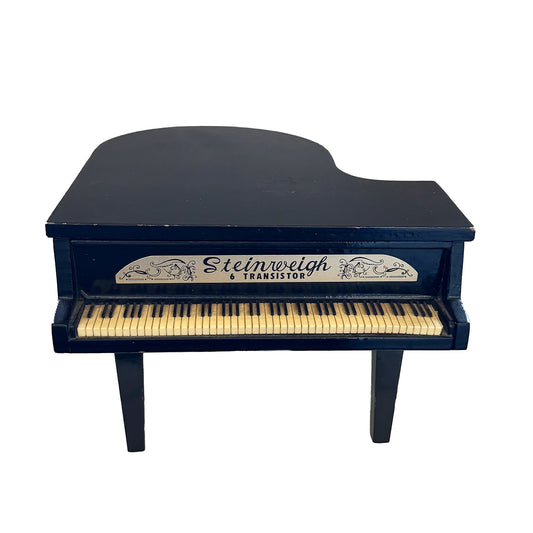 Model of a Steinweiss grand piano on a white background