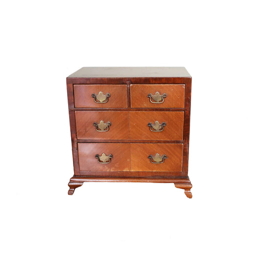 Wooden dresser with four drawers on a white background