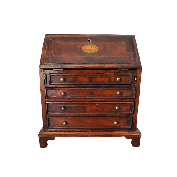Georgian antique miniature bureau with multiple drawers on a white background