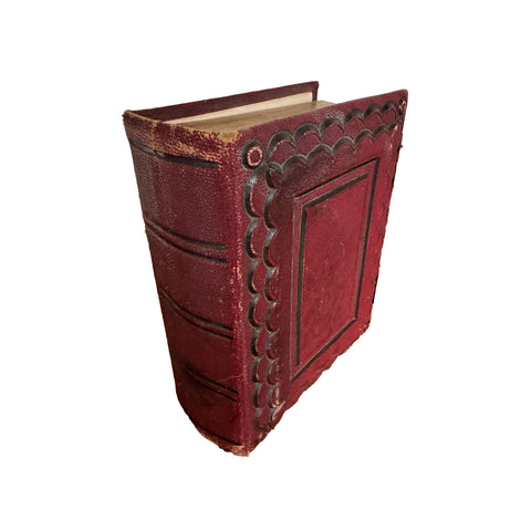 Vintage red leather-bound book on a white background