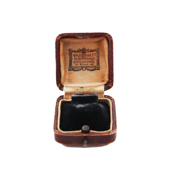 antique brown leather jewelry box with black interior on a white background