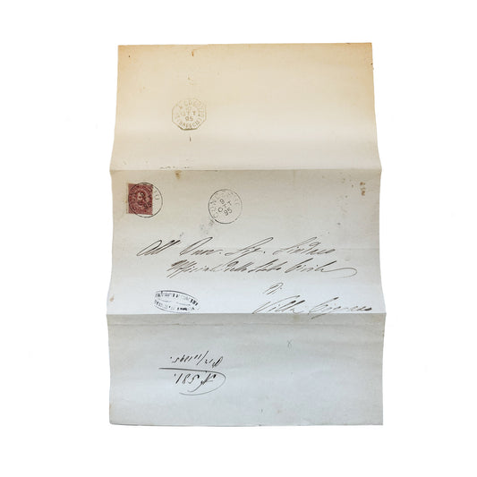 Antique Italian handwritten letter envelope with a postage stamp and date stamp, displayed in an open position, showing the address and signature.
