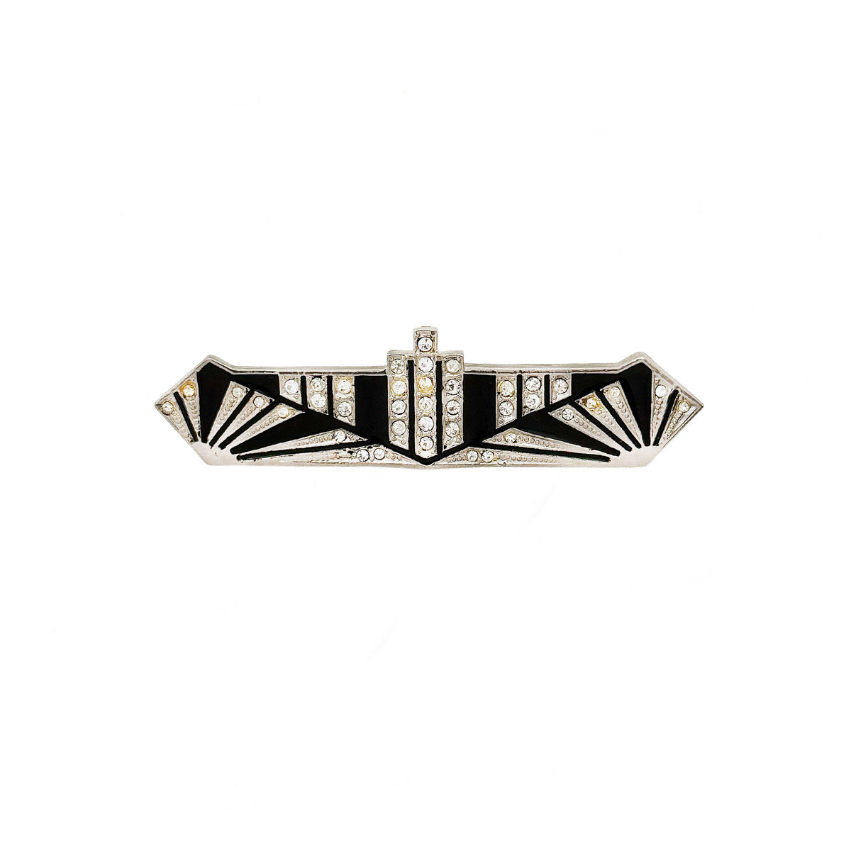 Decorative brooch with black and white design on a white background