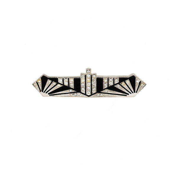 Decorative brooch with black and white design on a white background