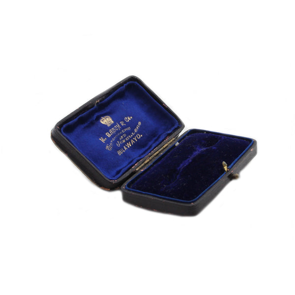 Open jewelry box with blue interior and visible branding on a white background