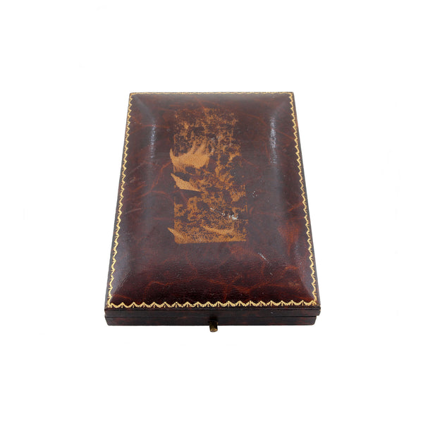 Vintage brown leather jewelry box with gold stitching on a white background
