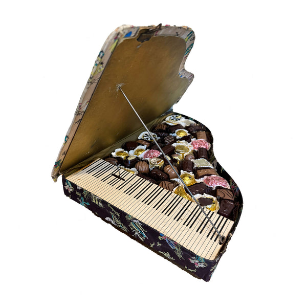Decorative box designed like a piano with floral patterns on a white background