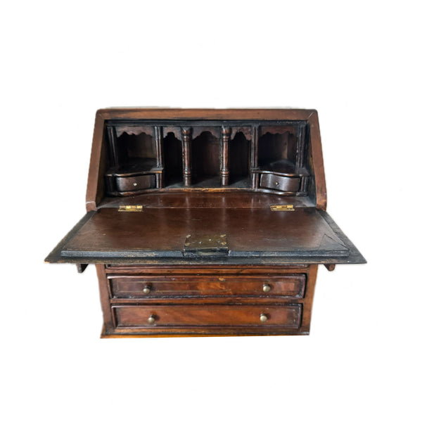 Wooden desk with hinged top on a white background