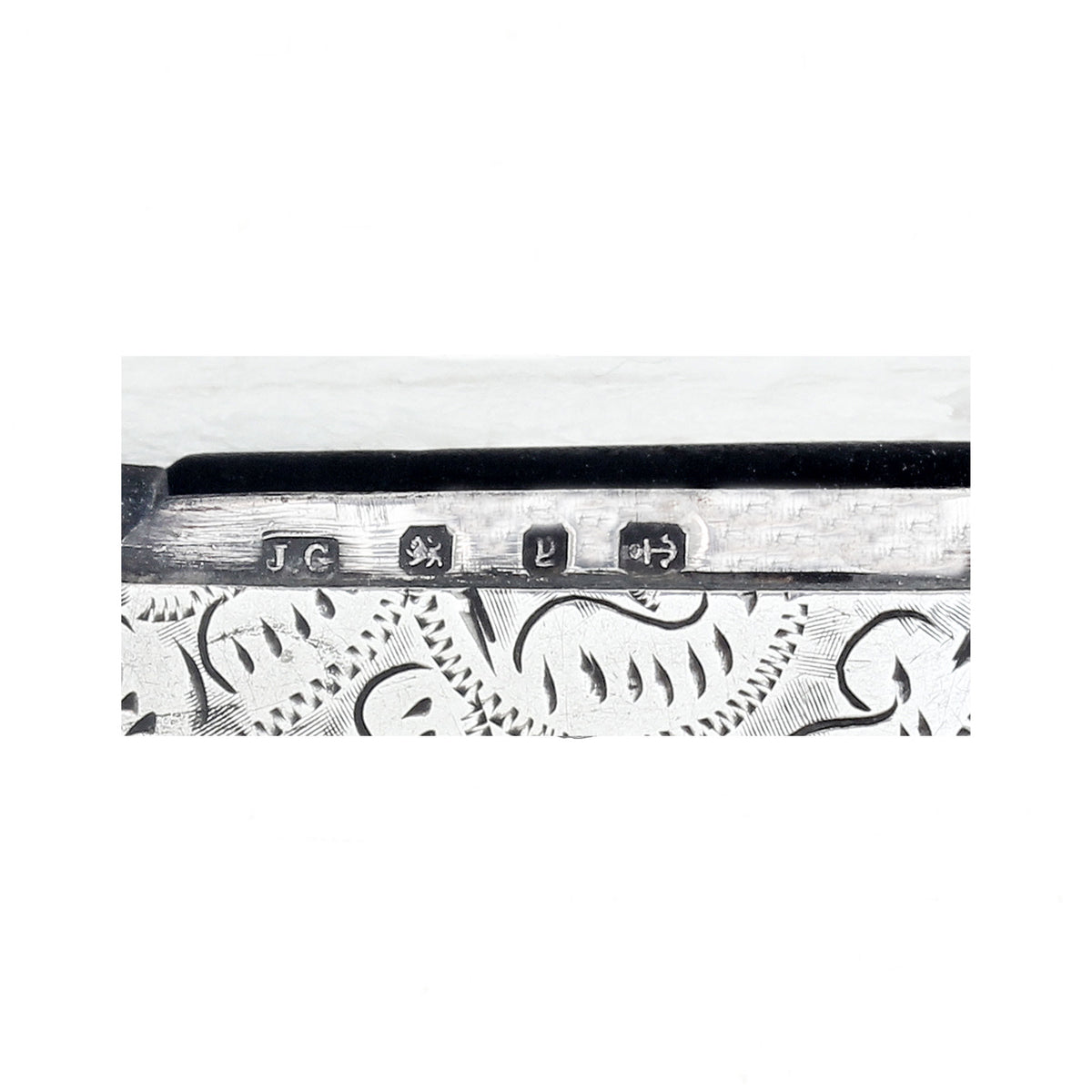 Decorative hallmark with engraved designs and symbols on a white background