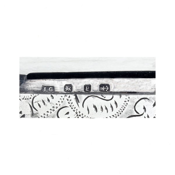Decorative hallmark with engraved designs and symbols on a white background