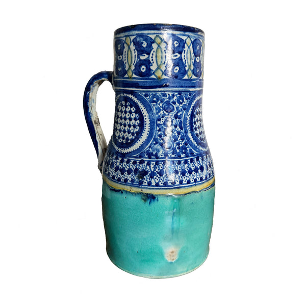 Ceramic pitcher with blue and white pattern on a white background