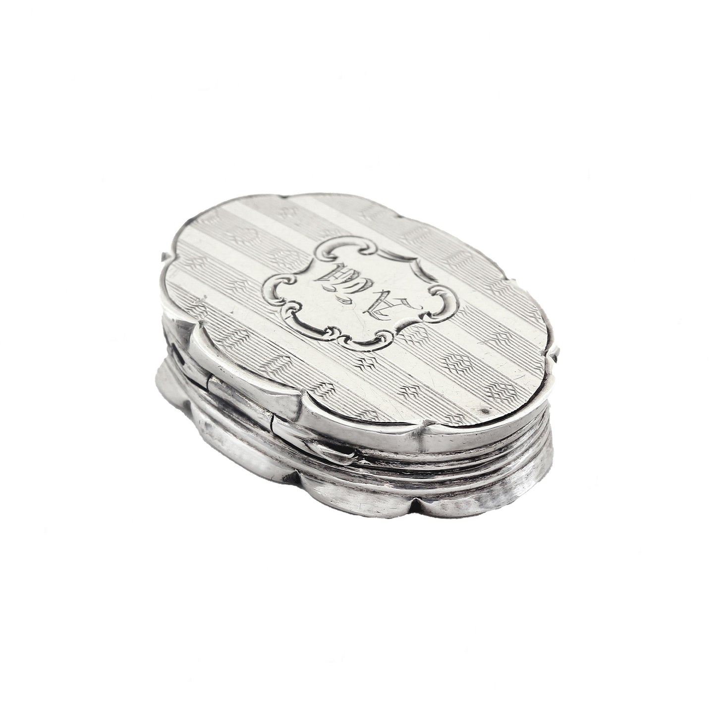 Silver vinaigrette with engraved design on a white background