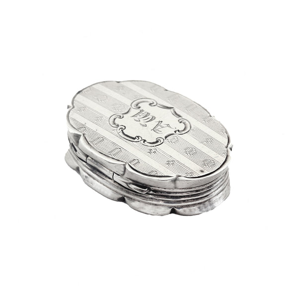 Silver vinaigrette with engraved design on a white background