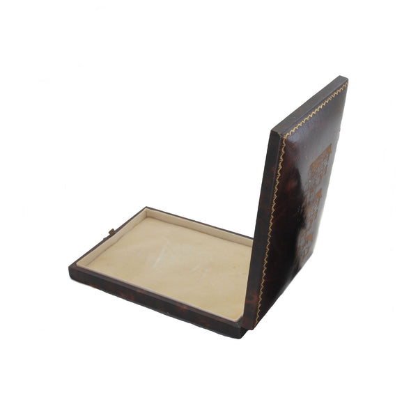Brown leather-bound book with a beige interior on a white background