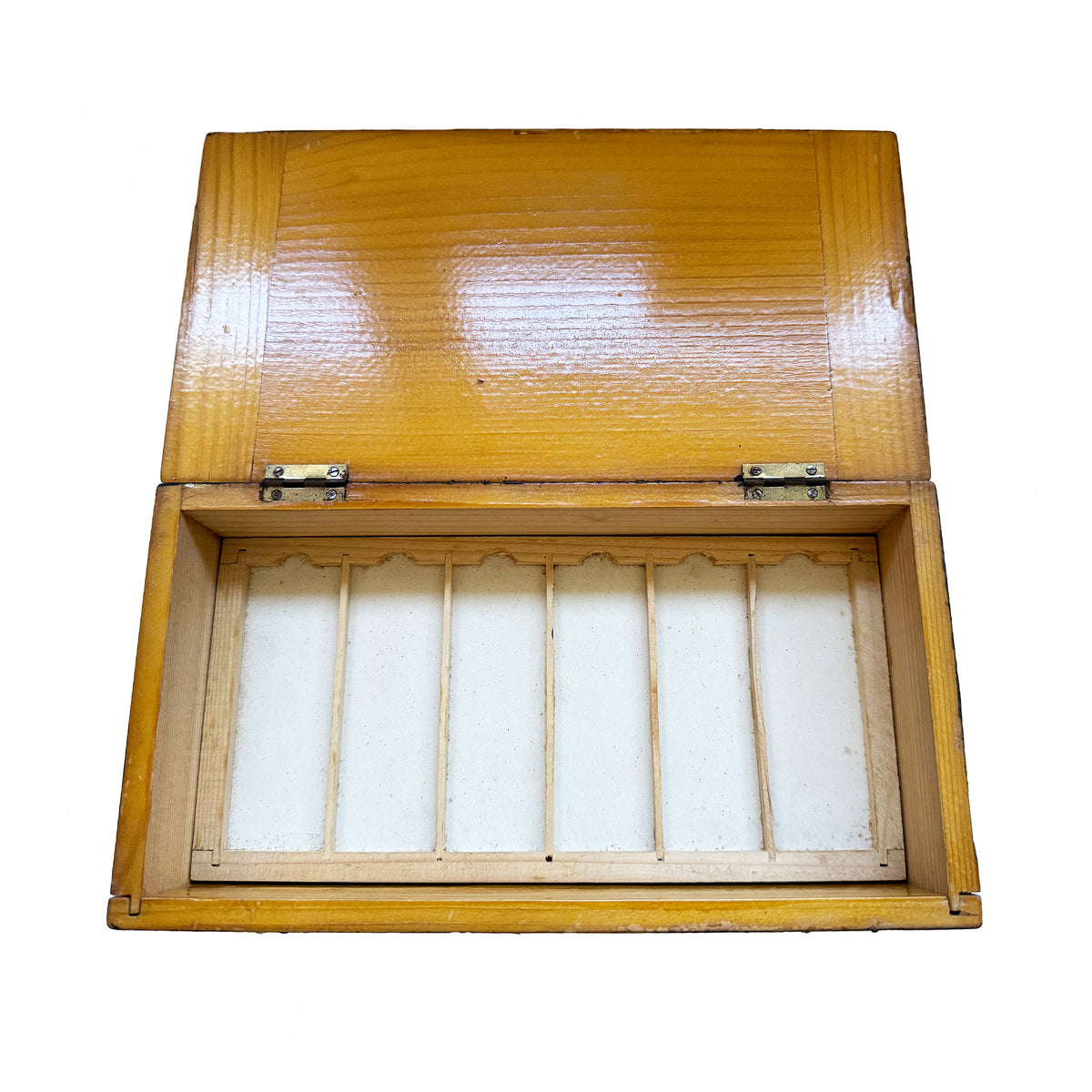 A wooden box of empty microscope slide trays