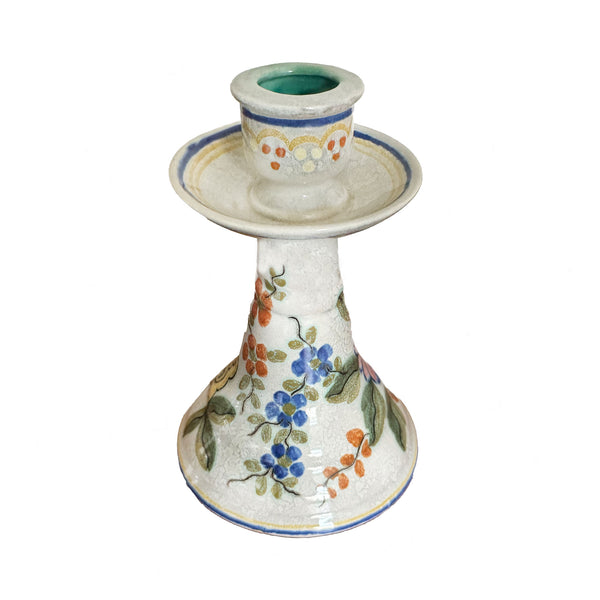 Ceramic candle holder with floral design on a white background