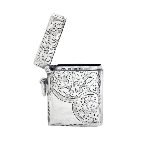 Silver vesta with intricate paisley patterns on a white background