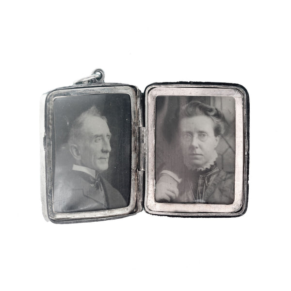 Vintage silver locket with portraits of a man and a woman on two sides.