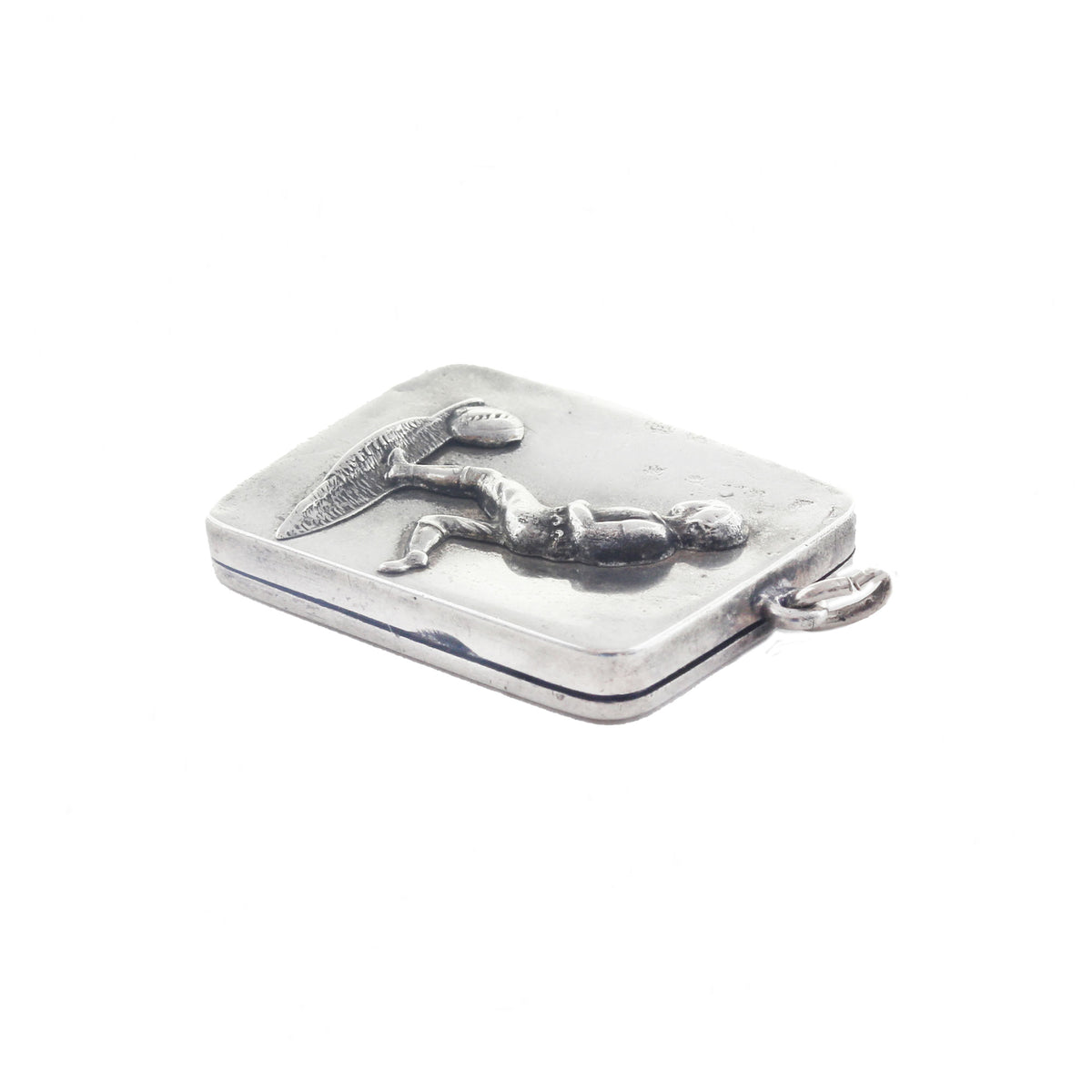Silver dog tag with a engraved design on a white background