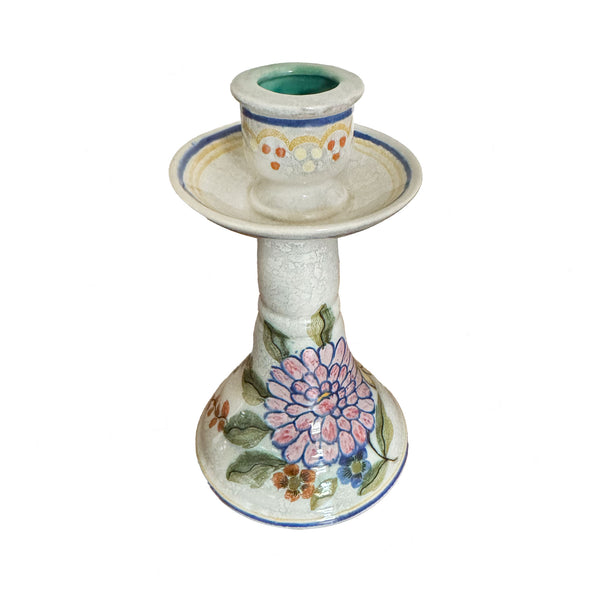 Ceramic candle holder with floral design on a white background
