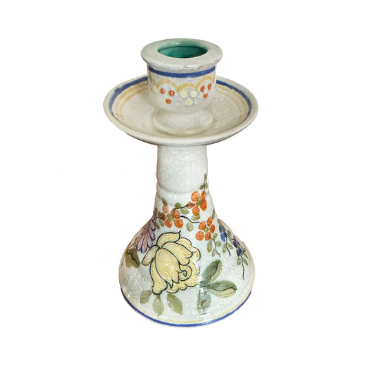 Decorative ceramic candle holder with floral patterns on a white background