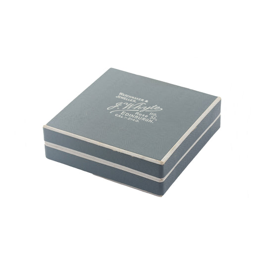 Grey jewelry box with white text on a white background