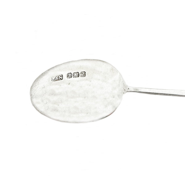 Silver spoon with visible hallmarks on a white background