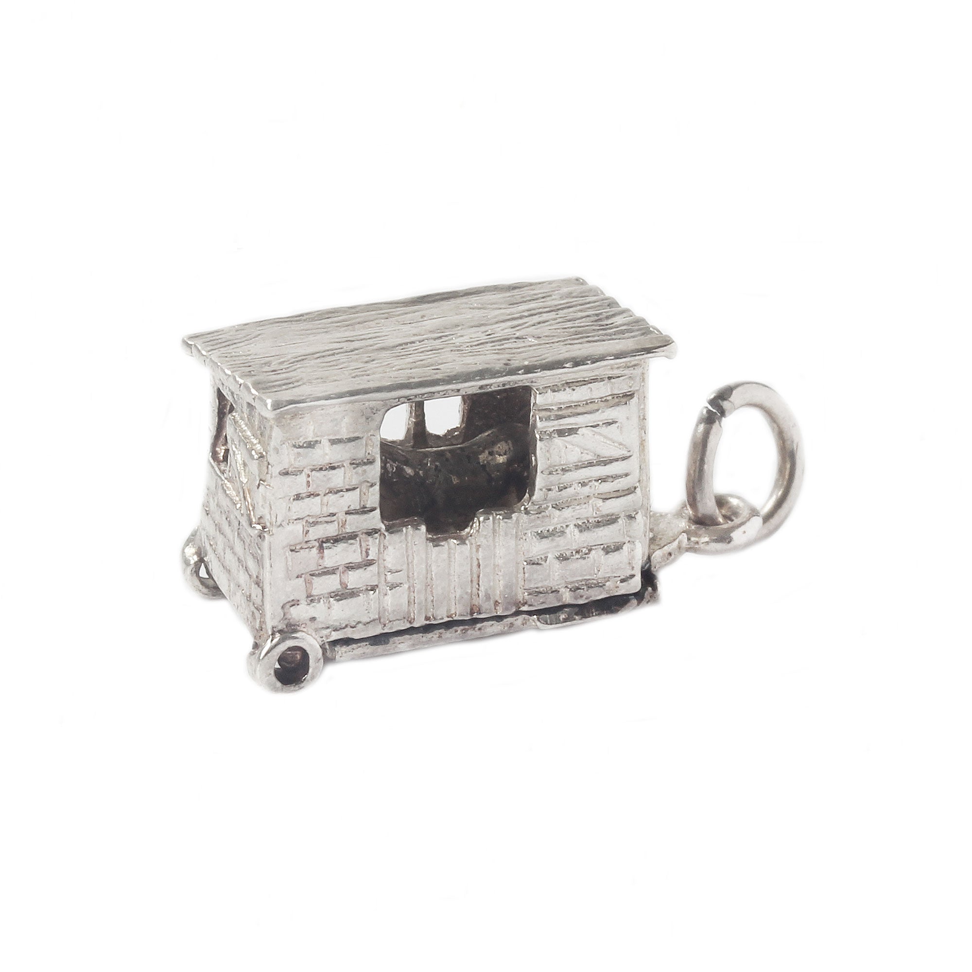 Silver charm shaped like a small house on a white background