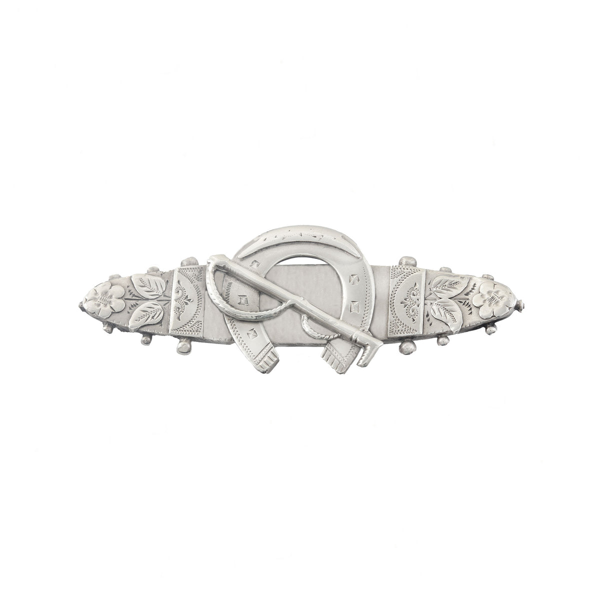 Decorative silver brooch with floral and horseshoe designs on a white background