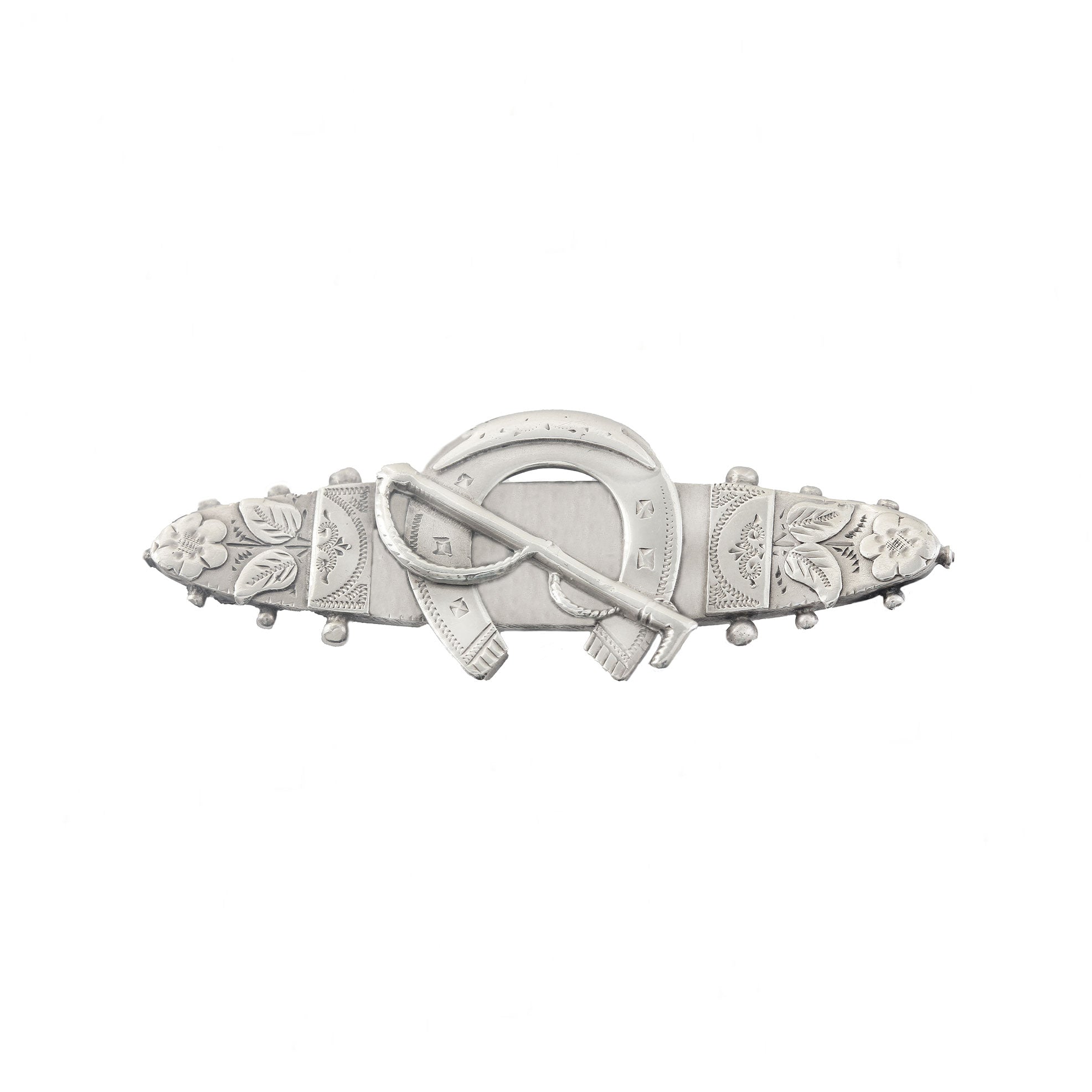 Decorative silver brooch with floral and horseshoe designs on a white background