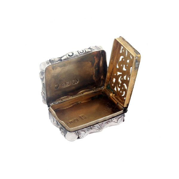 Silver and gold decorative box with open lid on a white background