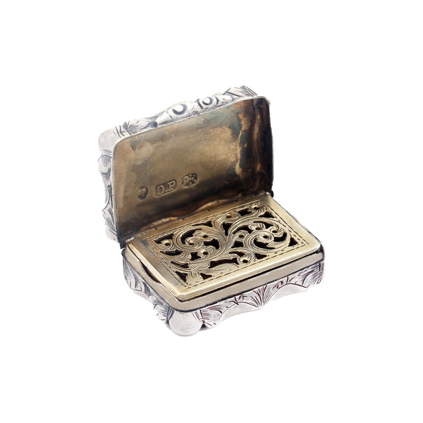 Decorative silver and gold box with intricate patterns on a white background