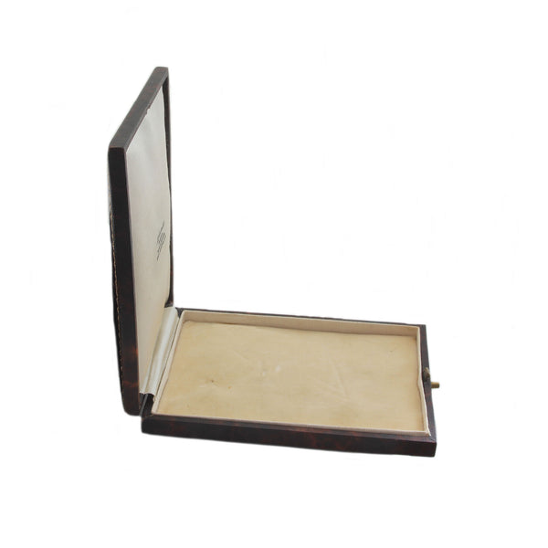 Open wooden jewelry box with a white interior on a white background