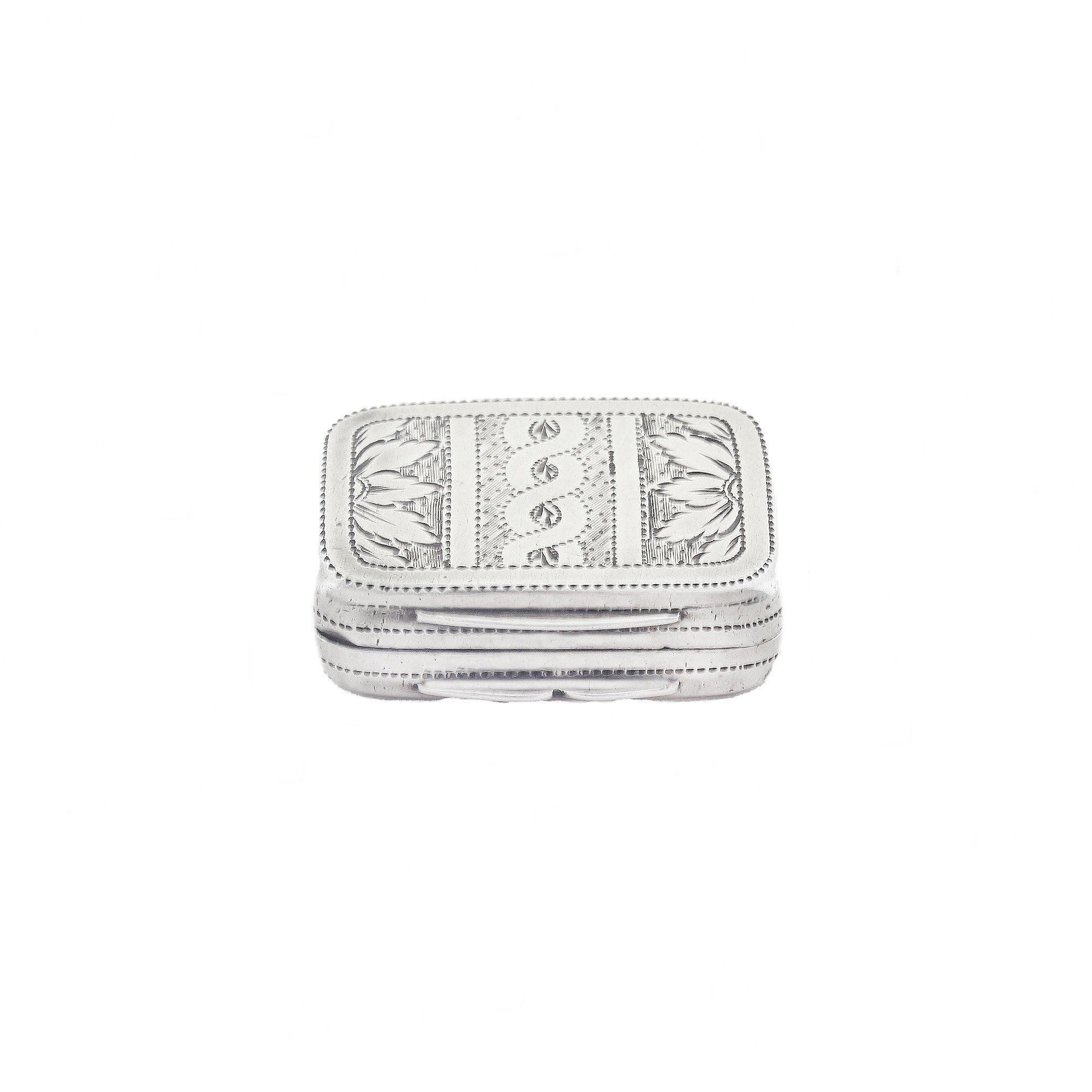 Silver vinaigrette with intricate patterns on a white background