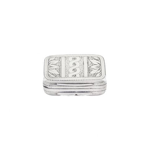 Silver vinaigrette with intricate patterns on a white background